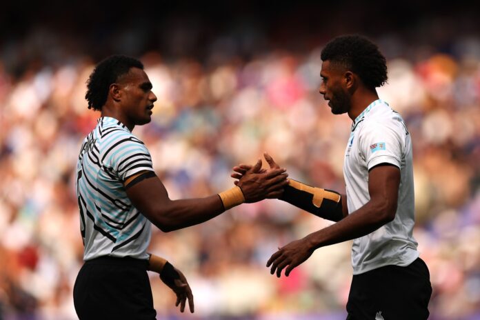 Ponipate Loganimasi and Iosefo Masi of Fiji celebrate after scoring a try in the Men's Rugby Sevens.