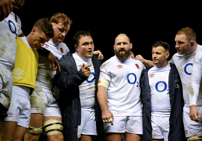 Jamie George of England is in conversation with his teammates.