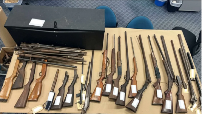 Two individuals were arrested after a significant number of firearms were discovered